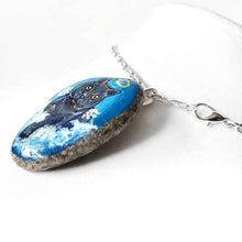 Load image into Gallery viewer, art of a dark gray / black british shorthair cat as an angel, is hand painted on a river rock, and is available as either a keepsake or a pendant necklace