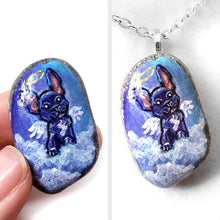 Load image into Gallery viewer, a small beach stone painted with dog art: a black french bulldog as an angel in the clouds. available as a stone keepsake or a pendant necklace