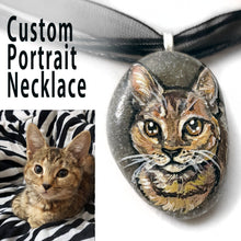 Load image into Gallery viewer, a small beach stone, hand painted with the portrait of a brown tabby cat, and made into a pendant necklace
