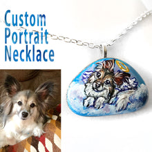 Load image into Gallery viewer, A custom pet portrait necklace, painted on a beach rock, of a papillon dog, painted as an angel.