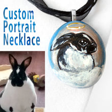 Load image into Gallery viewer, a custom portrait necklace of a black and white rabbit painted as an angel, on a small beach rock