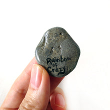 Load image into Gallery viewer, a smooth beach stone, hand painted with a portrait of a shiba inu dog as an angel, sitting on clouds against a light blue sky. available as a keepsake or pendant necklace. back signed with rainbowofcrazy