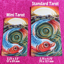 Load image into Gallery viewer, The World tarot card from the Animism Tarot Mini Borderless Edition, next to the standard tarot sized card