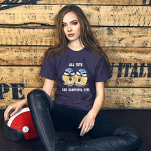 Load image into Gallery viewer, A woman wearing the Beautiful Tits Premium Unisex T-shirt in heather midnight navy, with art of two blue tit birds, and the words, "all tits are beautiful tits"