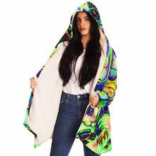 Load image into Gallery viewer, a woman wears the bunny lovers rainbow cloak, featuring a bright, all-over rainbow print of different rabbit breeds