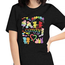 Load image into Gallery viewer, A woman wearing the Candy Lovers Premium Unisex T-shirt in black heather, which includes an illustration of 10 types of rainbow candy