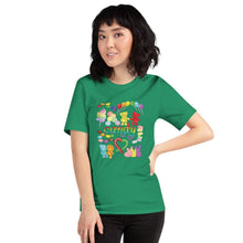Load image into Gallery viewer, A woman wearing the Candy Lovers Premium Unisex T-shirt in kelly green, which includes a graphic of 10 types of rainbow candy