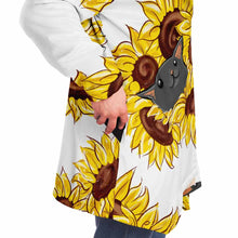 Load image into Gallery viewer, a man wears a white microfiber fleece cloak (with pockets), printed with sunflower art, with a black cat and white cat peeking out from the flowers