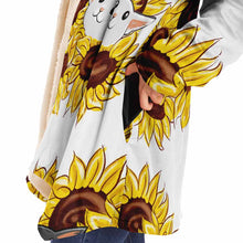 Load image into Gallery viewer, a woman wears a white microfiber fleece cloak (with pockets), printed with sunflower art, with a black cat and white cat peeking out from the flowers