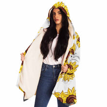 Load image into Gallery viewer, a woman wears a white microfiber fleece cloak (with pockets), printed with sunflower art, with a black cat and white cat peeking out from the flowers