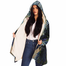Load image into Gallery viewer, a woman wearing a navy blue and orange cloak, featuring art from the Eight of Cups card, from the Animism Tarot: a magpie, with wings spread, flies up into the night sky.