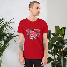 Load image into Gallery viewer, A man is wearing the Fox Love Premium Unisex T-shirt in the colour red, which includes a print of a red fox sleeping in the shape of a heart.