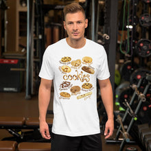Load image into Gallery viewer, A man wearing the Happy Cookies Premium Unisex T-Shirt in the colour white, featuring art of ten different types of cookies with smiling faces