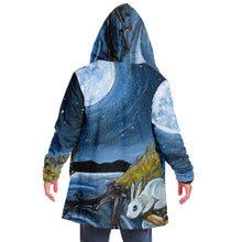 Load image into Gallery viewer, a man wearing the Moon Tarot Cloak, featuring art from the Animism Tarot: a white rabbit looks at the reflection of the moon in the water