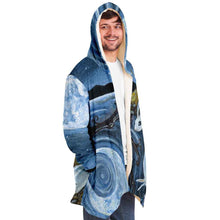 Load image into Gallery viewer, a man wearing the Moon Tarot Cloak, featuring art from the Animism Tarot: a white rabbit looks at the reflection of the moon in the water