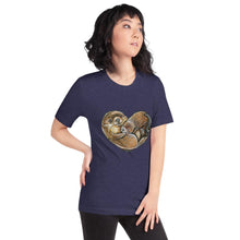 Load image into Gallery viewer, A woman wearing the Otters Love Premium Unisex T-Shirt in the colour heather midnight navy blue, which includes an illustration of two otters forming the shape of a heart.
