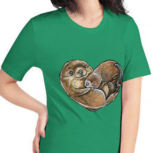 Load image into Gallery viewer, A woman wearing the Otters Love Premium Unisex T-Shirt in the colour kelly green which includes a graphic of two otters forming the shape of a heart.