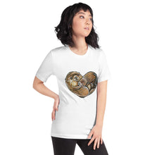 Load image into Gallery viewer, A woman wearing the Otters Love Premium Unisex T-Shirt in the colour white, which includes art of two otters forming the shape of a heart.
