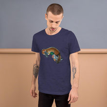 Load image into Gallery viewer, A man is wearing the Platypus Duck Premium T-Shirt in the colour heather navy blue, which includes a print of platypus kissing a mallard duck