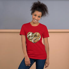Load image into Gallery viewer, A woman is wearing the Sloth Love Unisex Premium T-Shirt in the colour red, which includes art of a sloth forming the shape of a heart.