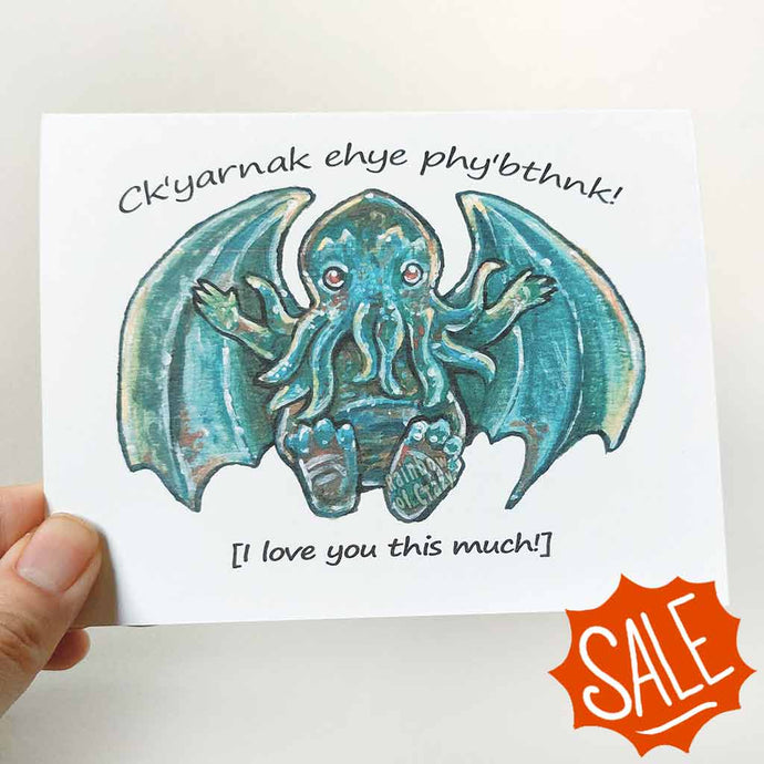 A greeting card with art of a baby Cthulhu with arms out stretched, with the words, 