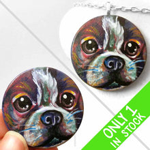 Load image into Gallery viewer, a wood disc is hand painted with a portrait of a boston terrier dog in rainbow colours. it&#39;s available as a wood keepsake or pendant necklace
