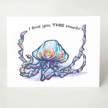 Load image into Gallery viewer, A greeting card, printed with art of blue and purple jellyfish, with two tentacles spread apart, it reads, &quot;i love you THIS much!&quot;
