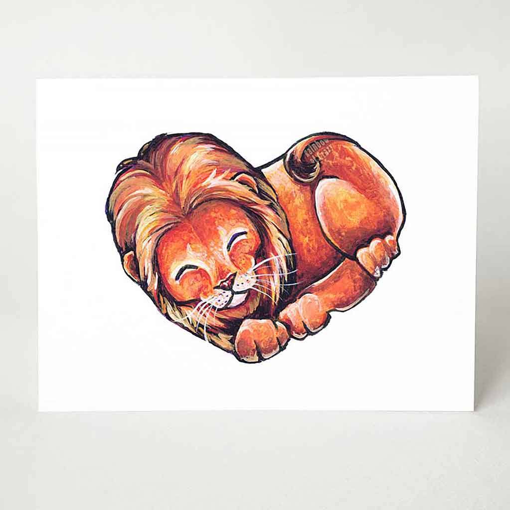 A greeting card, printed with an illustration of a lion, forming the shape of a heart.