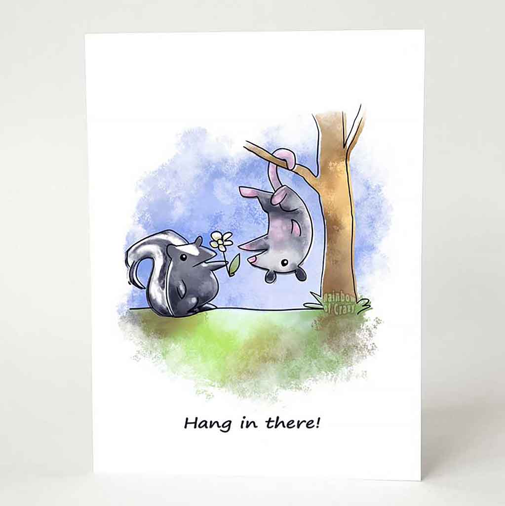 a greeting card printed with an illustration of a skunk holding out a flower towards a possum hanging upside down, with the text, 