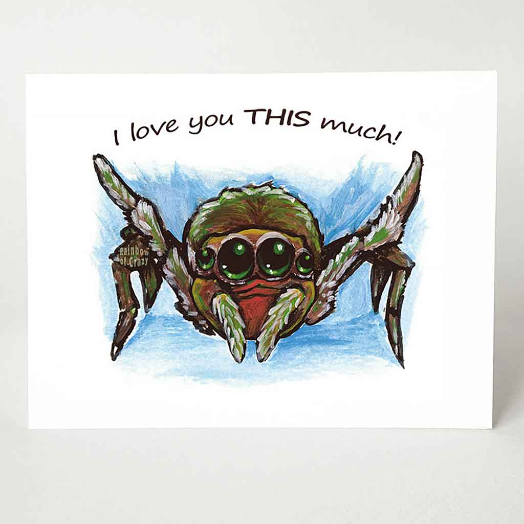 A greeting card printed with art of a brown and red baby spider, with its two front legs stretched out, the card reads, 