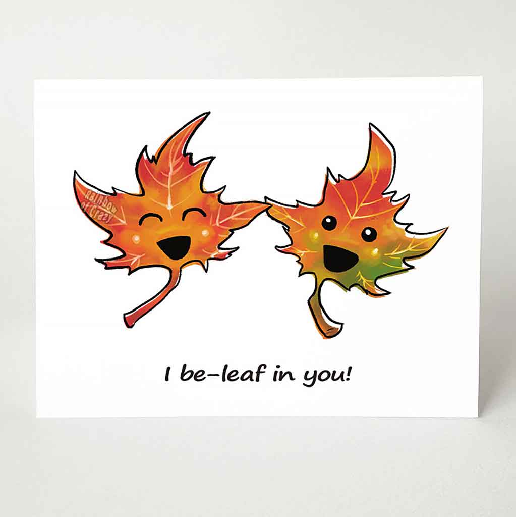 A greeting card with a graphic of two cartoon maple leaves with eyes and smiles, the card reads, 
