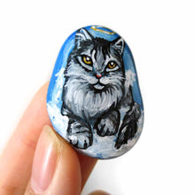 Load image into Gallery viewer, art of a silver gray maine coon cat as an angel, is hand painted on a river rock, and is available as either a keepsake, magnet or a pendant necklace
