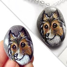 Load image into Gallery viewer, a beach rock painted with dog art: a portrait of a rough collie, available as either a keepsake, fridge magnet, or a pendant necklace
