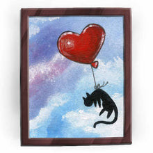 Load image into Gallery viewer, art print featuring an illustration of a black cat flying through a blue and purple sky with a red, heart shaped balloon tied to its waist.
