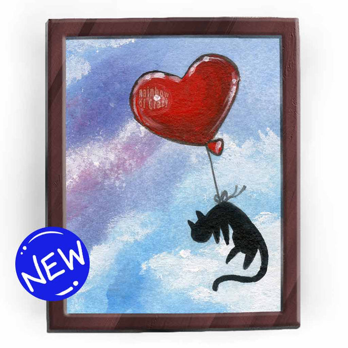 art print featuring an illustration of a black cat flying through a blue and purple sky with a red, heart shaped balloon tied to its waist.