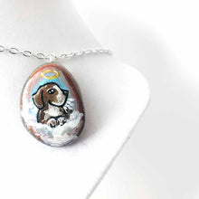 Load image into Gallery viewer, a small beach stone hand painted with the portrait of a beagle as an angel in the clouds, available as a keepsake or pendant necklace
