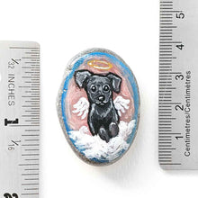 Load image into Gallery viewer, Small rock art of a black labrador retriever dog, painted as an angel, with halo and wings, sitting on clouds. available as a keepsake or pendant necklace
