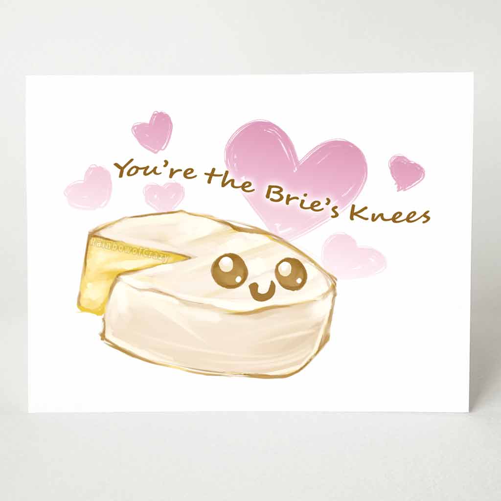 a greeting card with an illustration of a wheel of brie, with one slice missing. it has a smiley face on it. Text says 