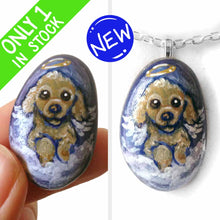 Load image into Gallery viewer, a small beach stone hand painted with the portrait of a brown poodle as an angel, sitting in the clouds against a blue sky. available as a keepsake or pendant necklace
