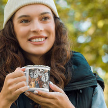 Load image into Gallery viewer, person smiling, holding a white enamel mug that has art of several different bunny rabbit breeds
