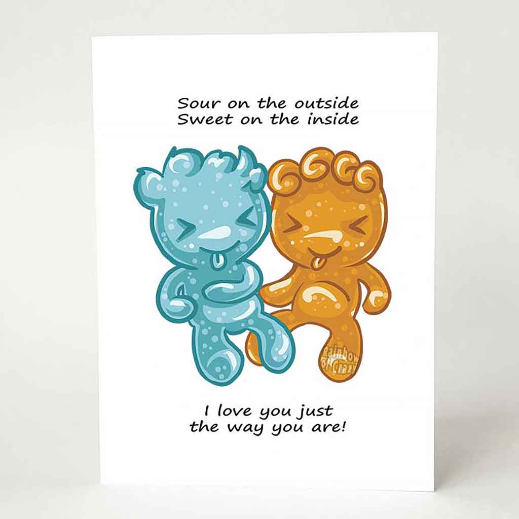 A greeting card with art of two sour candies in the shape of people (one blue, one orange), the card reads, 