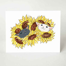 Load image into Gallery viewer, A greeting card featuring art of a black cat and white cat peeking out from a bunch of sunflowers.
