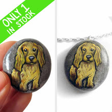 Load image into Gallery viewer, a beach stone hand painted with the portrait of a light brown cocker spaniel dog. this piece is available as a rock keepsake, or pendant necklace
