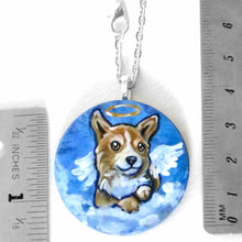 Load image into Gallery viewer, a small lightweight wood disc, hand painted with a portrait of a corgi at an angel in the clouds, against a blue sky, available as a keepsake or a pendant necklace
