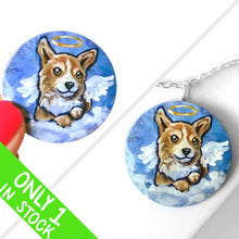 Load image into Gallery viewer, a small lightweight wood disc, hand painted with a portrait of a corgi at an angel in the clouds, against a blue sky, available as a keepsake or a pendant necklace
