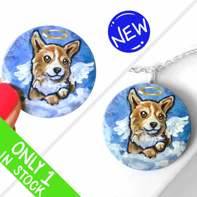 a small lightweight wood disc, hand painted with a portrait of a corgi at an angel in the clouds, against a blue sky, available as a keepsake or a pendant necklace