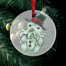 Load image into Gallery viewer, a round glass ornament, printed with an illustration of cthulhu as a snowman, complete with carrot nose and shiny black top hat
