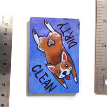 Load image into Gallery viewer, blue and purple wood magnet, hand painted with a corgi with a tail in a heart shape, tongue out, doing a sploot. near the top of the dog&#39;s head is the word CLEAN. written upside down next to the dog&#39;s butt is the word DIRTY
