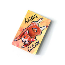 Load image into Gallery viewer, yellow and orange wood magnet, hand painted with a corgi with a tail in a heart shape, tongue out, doing a sploot. near the top of the dog&#39;s head is the word CLEAN. written upside down next to the dog&#39;s butt is the word DIRTY
