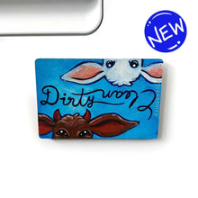 Load image into Gallery viewer, blue wood magnet, hand painted, bottom features a brown goat with little red horns with the word &quot;Dirty&quot; above them. at the top, upside down is a white goat, with the word &quot;clean&quot; above them
